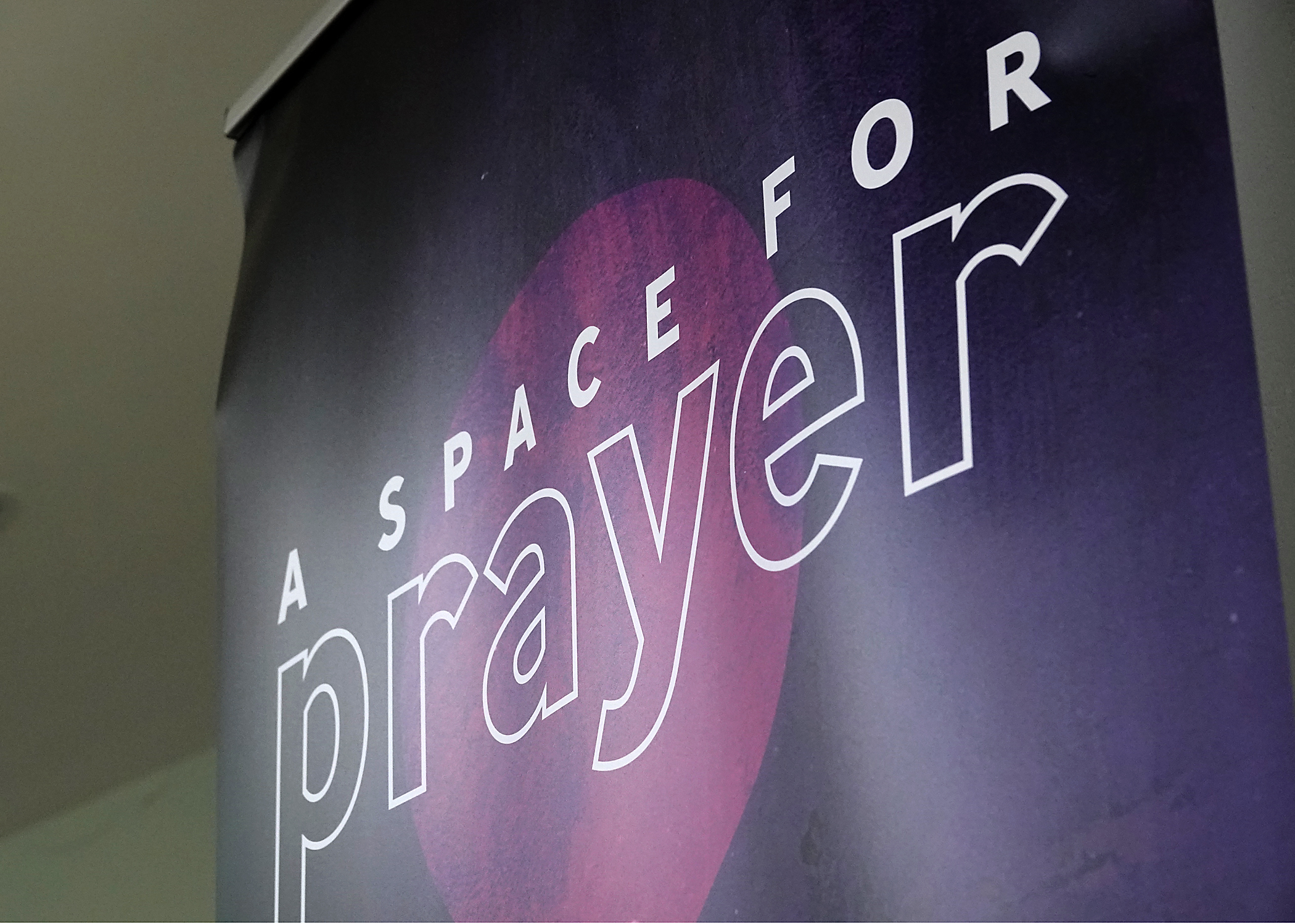 Photo of a dark colour banner saying A SPACE FOR PRAYER