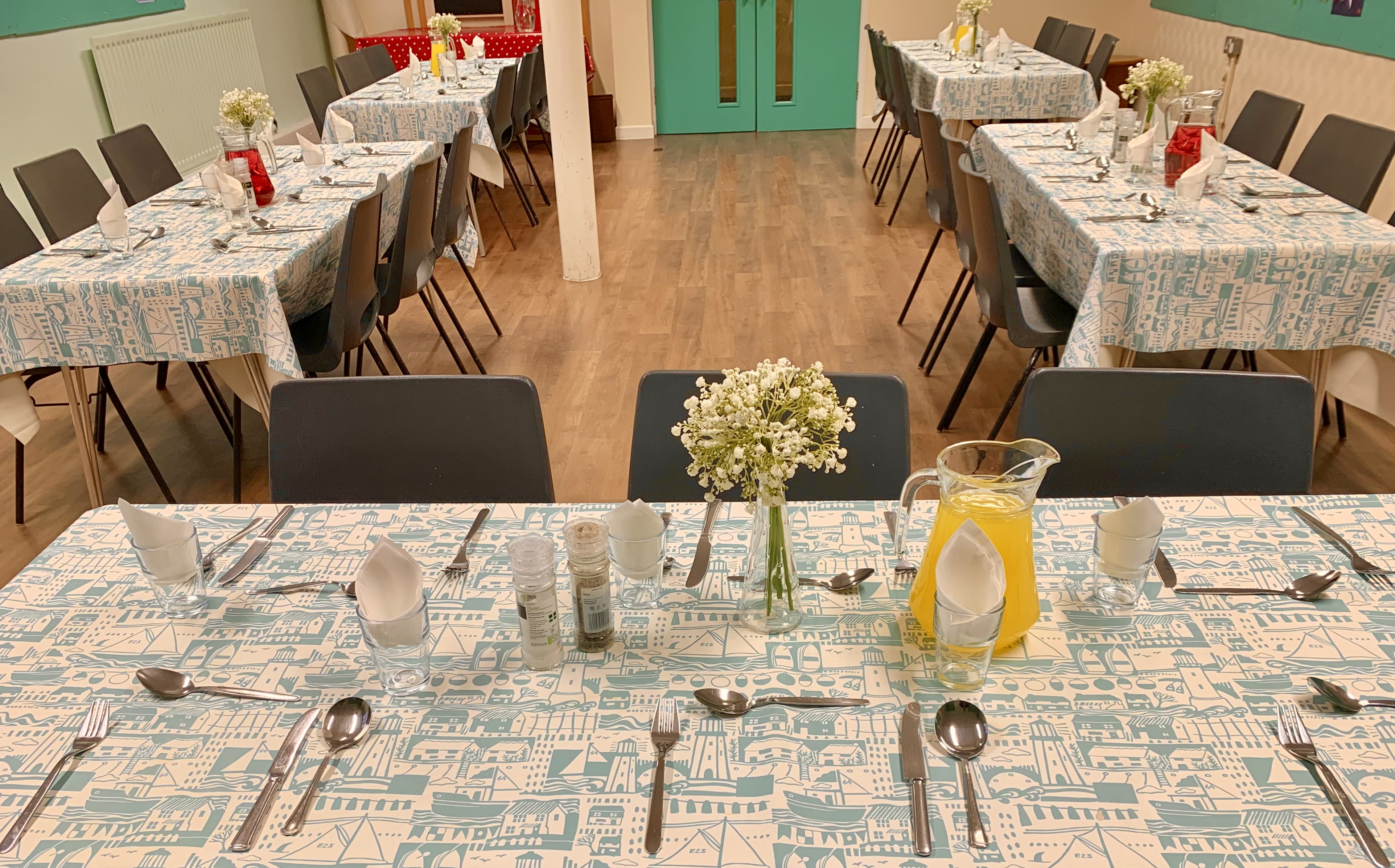 a group of dining tables laid for a hot meal
