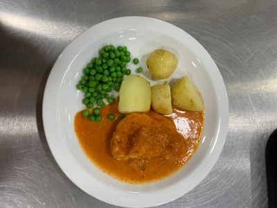 a plate of pie, potatoes, peas and gravy