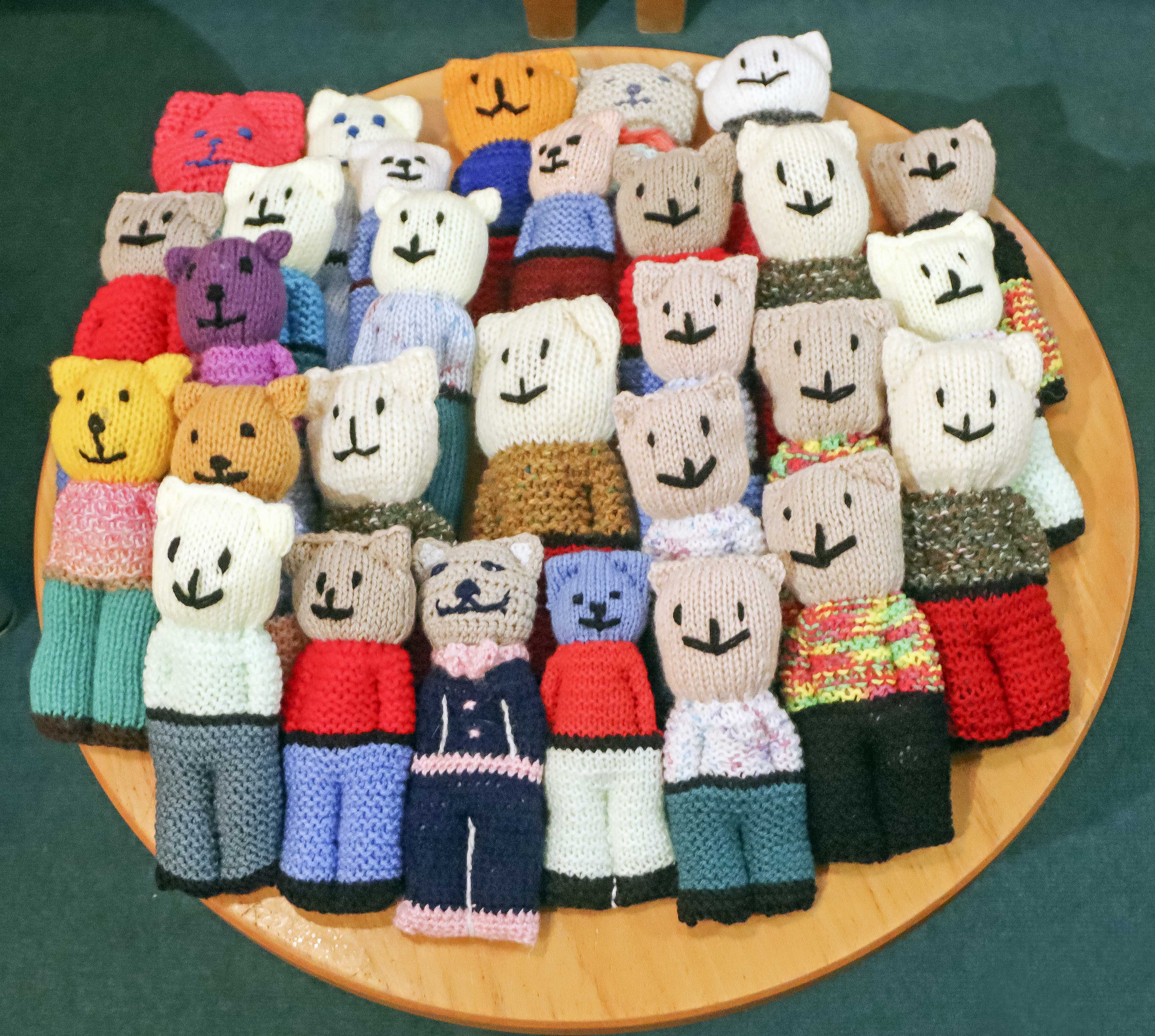 A table full of knitted teddy bears