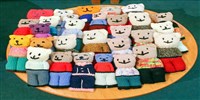 A table full of knitted teddies