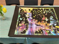 A table set with a partly made jigsaw puzzle