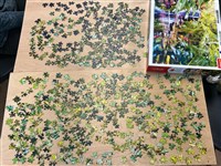 A second table set with a different partly made jigsaw puzzle